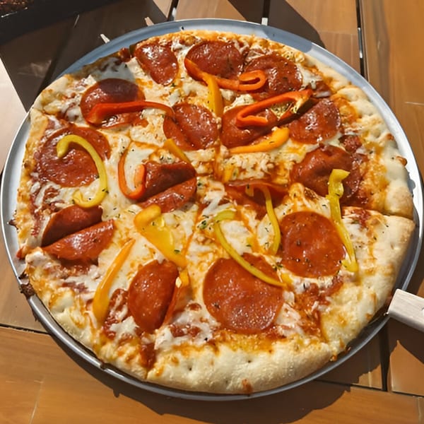 Coastal Pizza Kitchen's pepperoni pizza with red and yellow bell peppers on a metal tray.